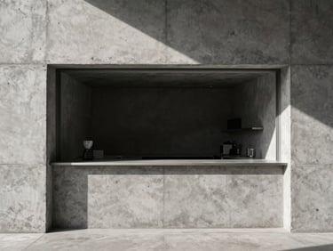 Minimalist architectural photography of a raw concrete coffee bar, sharp natural light and deep shadows, high contrast, 35mm