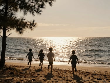 Wide shot of children running towards the Atlantic ocean at golden hour, silhouettes against the sparkling water, pine trees framing the left edge, archival film texture.