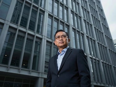 Professional portrait of a Malaysian BIM specialist, serious and confident, cool tones
