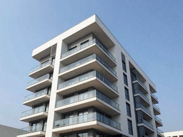Modern luxury apartment building exterior in East Legon, glass balconies, blue sky, bright daylight