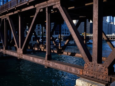 Close-up of steel bridge details over the Chicago River, geometric lines, dramatic shadows