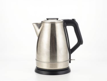 Bright studio shot of a modern electric kettle and hand blender on a clean counter, metallic accents, high-key lighting
