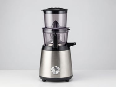 Bright high-key studio product shot of a premium juicer mixer grinder with heavy stainless steel jars on a clean light gray background, sharp focus