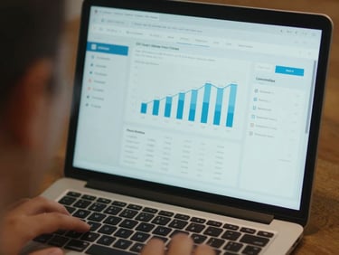 Close-up of a laptop screen displaying a clean energy analytics dashboard, warm ambient light, crisp focus