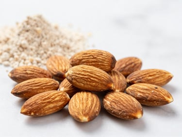 Bright high-key food photography, close-up of raw almonds and clean protein sources on a white marble background, crisp details.