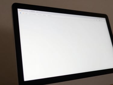 Close-up of a clean, simplified UI mockup showing an elegant software screen on a minimal monitor, soft daylight.