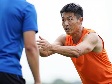 Focused athletic coach instructing an athlete during a high-motion training state, bright high-key lighting, sharp action freeze-frame