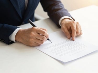 Close up of hands signing a contract document on a clean modern desk, soft daylight, warm tones