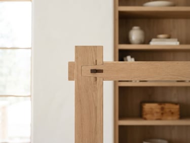 Straight-on architectural detail of tight timber-frame joinery on a custom built-in shelf, bright natural mountain daylight streaming from the side, clean neutral tones, sharp focus, 35mm lens