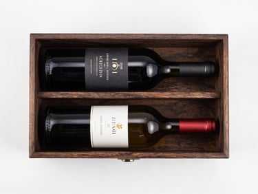 Overhead flat-lay of a premium wine gift case with two bottles and dark wood insert on a clean white background, bright even studio lighting, packaging detail fully visible