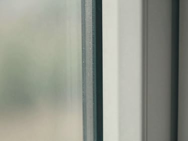 Macro close-up of a pristine, restored glass pane edge meeting a clean slate frame, highlighting absolute transparency and zero residue under sharp daylight.