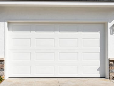 Pristine white garage door on a modern home exterior under bright saturated afternoon sunlight, clean shadows, sharp focus