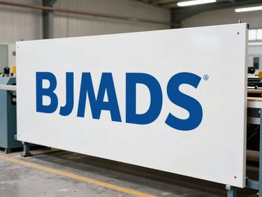 Medium-wide shot of a large-format sign being produced in a workshop, showing industrial machinery and clean lighting, crisp details