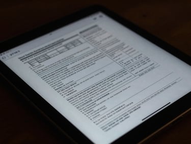 Close-up of a secure digital interface on a tablet, displaying maritime documents and data, with dark, reflective screen and soft ambient light.