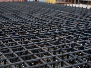 Close-up of precise steel reinforcement mesh before concrete pouring on a construction site, overcast day, sharp focus