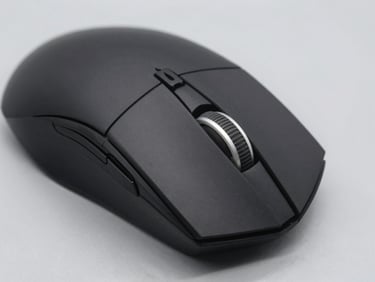 Close-up of a matte black gaming mouse showing tactile scroll wheel, crisp product photography, clean studio lighting, soft shadows, neutral light gray background
