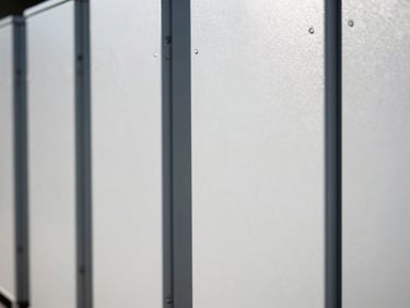 Tight macro shot of sleek commercial battery storage units, crisp high-contrast lighting, technical industrial aesthetic.