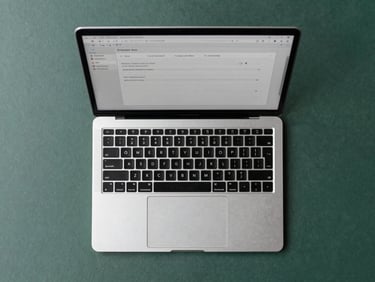 Top-down flatlay of a clean modern office desk with a laptop displaying a simple form, natural cool daylight, sharp focus, 35mm