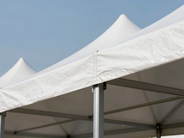 Close-up of a premium double-stitch seam on a white event tent tensioned over a heavy-duty steel frame