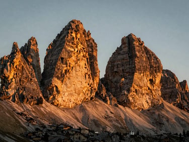 Dramatic jagged peaks of the Italian Dolomites at sunrise, golden light hitting the rock faces