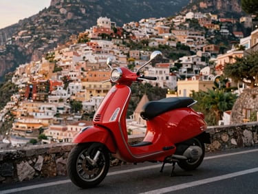 A vintage red Vespa parked on a cliffside road overlooking Positano, warm twilight