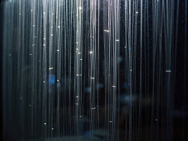 Abstract representation of clean data streams reflecting off a dark glass pane, sharp white highlights