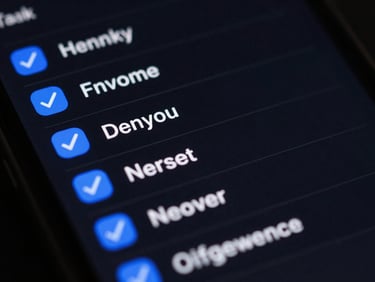 Macro close-up of a mobile screen displaying a dark-mode task list application, electric blue check marks, clean typography, low-key studio lighting.