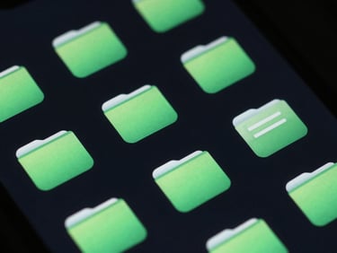 Macro close-up of a mobile screen showing a dark-mode file browser interface, neon green folder icons, crisp vector UI, low-key studio lighting.