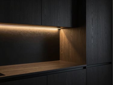 Moody architectural close-up of a minimalist kitchen at dusk, dark textured oak cabinets, soft golden light strip illuminating seamless joints, Hasselblad medium format