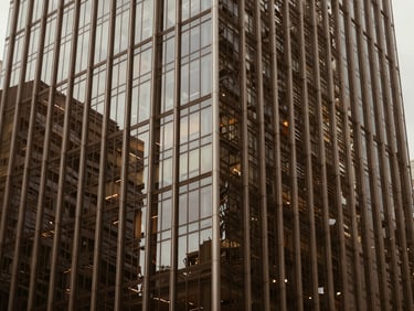 Modern glass skyscraper facade in Singapore, crisp daylight, architectural framing, warm tones