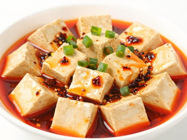 Close-up of Mapo Tofu with vibrant red chili oil and green scallions, bright high-key food photography, clean white background