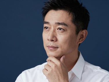 Elegant close-up portrait of a male radio host in soft studio lighting, thoughtful expression, professional editorial style, 35mm