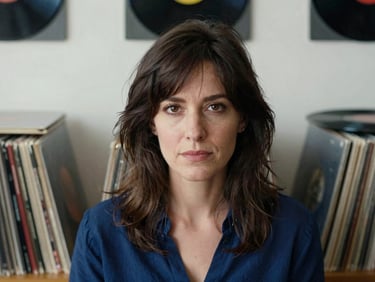 Elegant close-up portrait of a female musicologist in a studio filled with vinyl records, warm soft lighting, 35mm