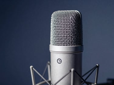 Macro shot of a high-end studio microphone, soft diffused studio lighting, deep blue and white tones, shallow depth of field, 35mm.