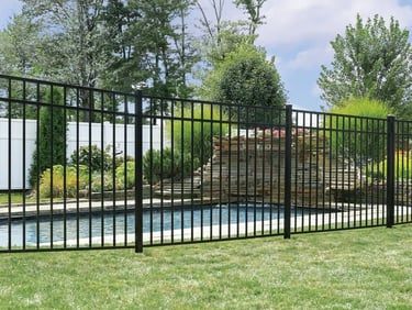 Modern black aluminum pool fence installed around a backyard swimming pool in Townsend DE