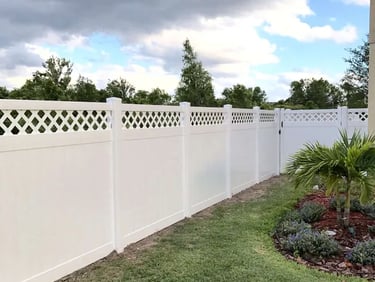 White vinyl privacy fence with a decorative lattice top installed in a Bear DE residential backyard.