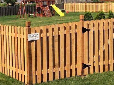 A wooden spaced picket fence with a gate encloses a backyard in Townsend DE