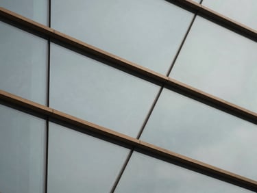 Abstract representation of a technology network using intersecting glass panels, desaturated cool tones, sharp focus.