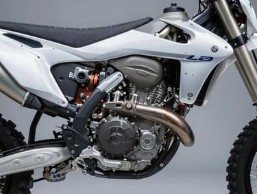 Crisp industrial photography of a heavy-duty adventure motorcycle, exposed engine block, metallic silver paint, cool high-contrast studio lighting, 50mm lens