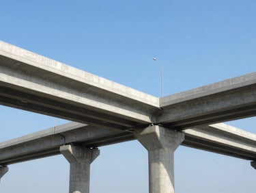 Completed clean concrete infrastructure highway bridge under clear blue sky, wide-angle environmental shot, professional architectural lens.