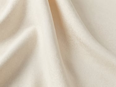 Close-up of elegant draped cream textile, soft shadow, natural light, high-end minimalist B2B textile presentation