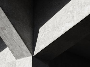 Abstract close-up of sharp architectural concrete angles under harsh, direct sunlight, creating deep black shadows, high-contrast, 35mm photography.
