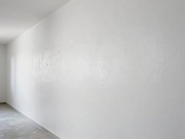 After state of the same hallway wall, freshly coated in clean white, smooth surface, natural light from above, sharp edges at ceiling and floor