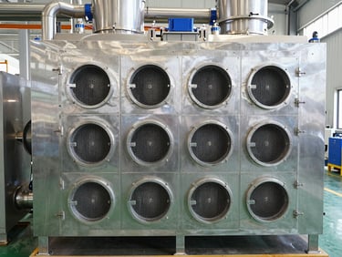 Straight-on shot of an industrial water chiller unit, stainless steel exterior, visible pipes, bright lighting.