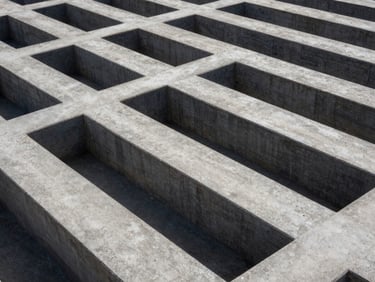 High-contrast geometric pattern of concrete structures and sharp shadows under crisp daylight, wide environmental framing.