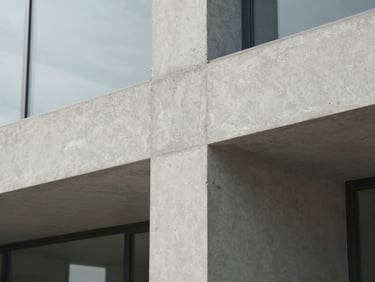 Macro detail of architectural textures, clean concrete and glass under soft natural light, minimalist composition, muted cool tones