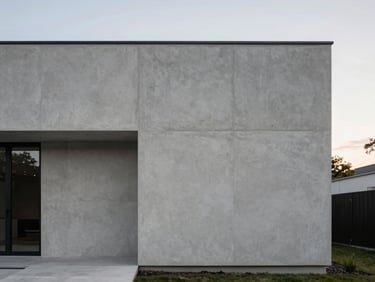 Minimalist modern home exterior, crisp geometric concrete lines, soft natural evening daylight, 35mm architectural photography