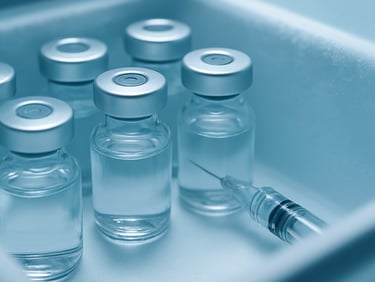 Macro clinical shot of sealed vaccine vials and sterile injectables in a cold chain storage container