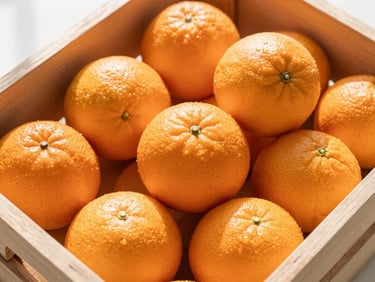 Overhead shot of fresh organic oranges in a wooden crate, bright morning sun