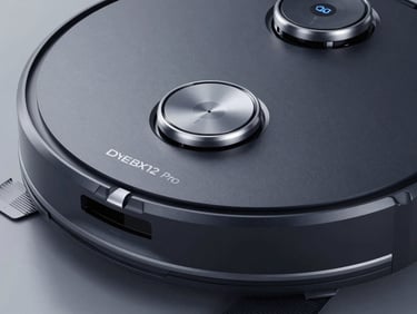 Macro shot of DEEBOT X12 Pro Omni in dark textured casing, silver accents, showing the targeted stain removal spray nozzle, studio lighting